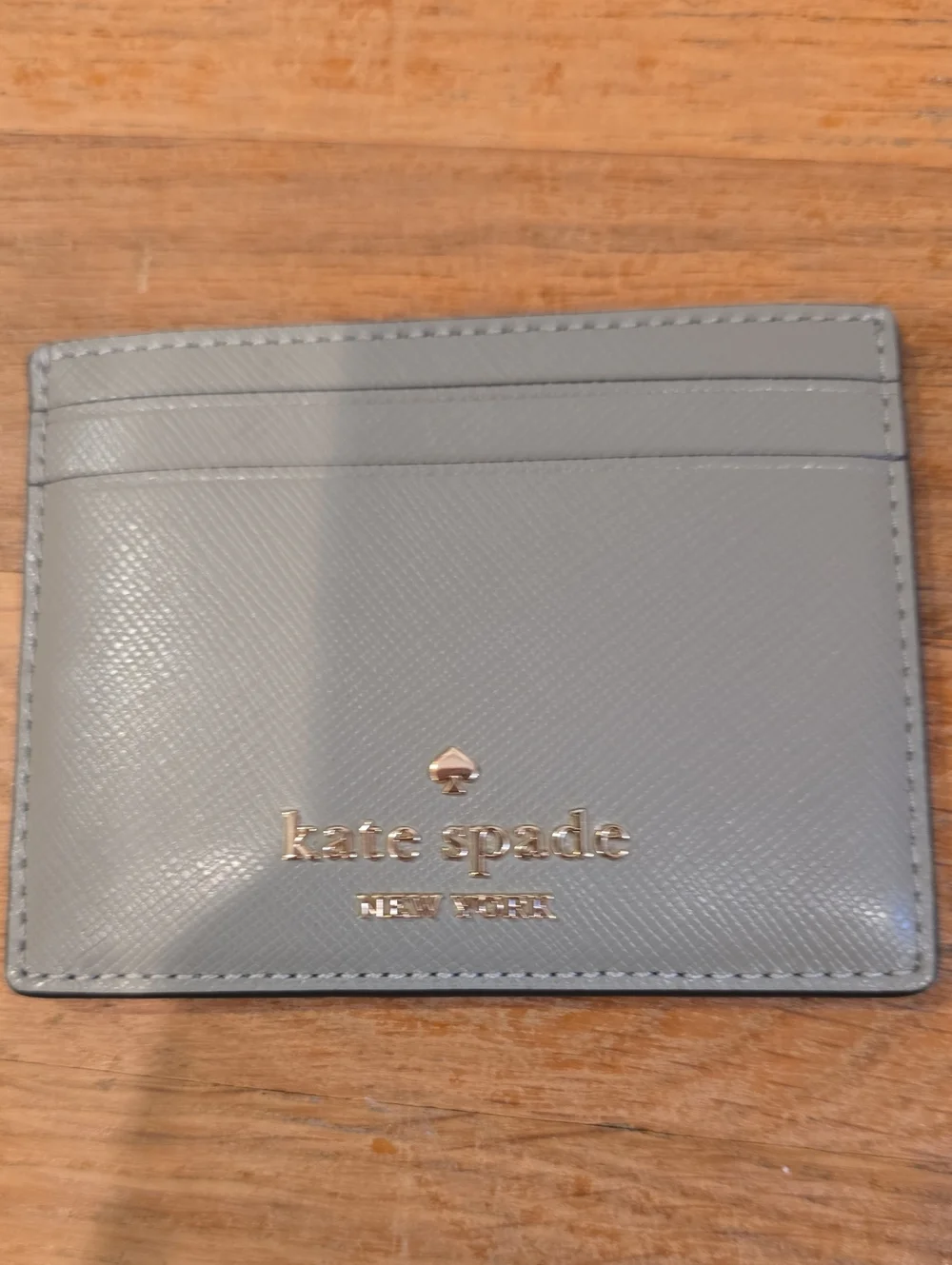 Kate Spade gray saffiano card holder with gold logo